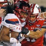 Arizona running back Gary Brightwell, left, is tackled by Utah defensive end Caleb Repp, right, in the second half during an NCAA college football game Friday, Oct. 12, 2018, in Salt Lake City. (AP Photo/Rick Bowmer)