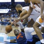 Oklahoma City Thunder forward Nerlens Noel (3) tries to keep the ball away from Phoenix Suns center Tyson Chandler (4) and forward T.J. Warren (12) in the first half of an NBA basketball game in Oklahoma City, Sunday, Oct. 28, 2018. (AP Photo/Sue Ogrocki)