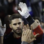 Boston Red Sox's J.D. Martinez celebrates in the dugout after hitting a solo home run against Los Angeles Dodgers' Clayton Kershaw during the seventh inning in Game 5 of the World Series baseball game on Sunday, Oct. 28, 2018, in Los Angeles. (AP Photo/David J. Phillip)