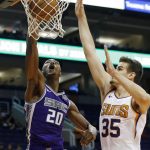 Sacramento Kings forward Harry Giles (20) dunks over Phoenix Suns forward Dragan Bender (35) during the first half of a preseason NBA basketball game Monday, Oct. 1, 2018, in Phoenix. (AP Photo/Ross D. Franklin)