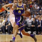 Los Angeles Lakers forward Kyle Kuzma (0) drives as Phoenix Suns forward Ryan Anderson defends during the first half of an NBA basketball game, Wednesday, Oct. 24, 2018, in Phoenix. (AP Photo/Matt York)
