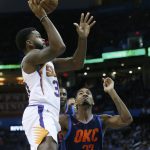 Phoenix Suns guard Troy Daniels (30) shoots in front of Oklahoma City Thunder guard Terrance Ferguson (23) in the first half of an NBA basketball game in Oklahoma City, Sunday, Oct. 28, 2018. (AP Photo/Sue Ogrocki)