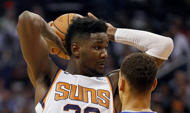Phoenix Suns center Deandre Ayton (22) looks to pass as Dallas Mavericks forward Dwight Powell (7) ...