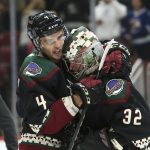 Arizona Coyotes goalie Antti Raanta (32) is embraced by teammate Niklas Hjalmarsson following a 7-1 victory against the Tampa Bay Lightning during an NHL hockey game, Saturday, Oct. 27, 2018, in Glendale, Ariz. (AP Photo/Ralph Freso)