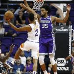 Sacramento Kings forward Marvin Bagley III (35) blocks the way to the basket against Phoenix Suns guard Elie Okobo (2) during the first half of a preseason NBA basketball game Monday, Oct. 1, 2018, in Phoenix. (AP Photo/Ross D. Franklin)