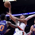 Portland Trail Blazers guard Wade Baldwin IV, center, passes the ball as Phoenix Suns forwards Josh Jackson, left, and Dragan Bender defend during the second half of an NBA preseason basketball game in Portland, Ore., Wednesday, Oct. 10, 2018. (AP Photo/Steve Dykes)