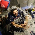 Los Angeles Dodgers starting pitcher Rich Hill is doused with liquid by teammates in the clubhouse after the team's 5-2 win against the Colorado Rockies in a tiebreaker baseball game, Monday, Oct. 1, 2018, in Los Angeles. (AP Photo/Jae C. Hong)