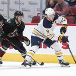 Buffalo Sabres center Jack Eichel (9) shields Arizona Coyotes right wing Mario Kempe from the puck in the second period during an NHL hockey game, Saturday, Oct. 13, 2018, in Glendale, Ariz. (AP Photo/Rick Scuteri)