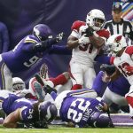 Arizona Cardinals running back David Johnson (31) scores on a 1-yard touchdown run ahead of Minnesota Vikings defensive tackle Linval Joseph, left, during the second half of an NFL football game, Sunday, Oct. 14, 2018, in Minneapolis. (AP Photo/Jim Mone)