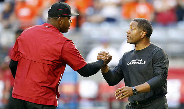 Arizona Cardinals quarterback coach Byron Leftwich, left, greets head coach Steve WIlks prior to an...