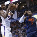 Phoenix Suns center Deandre Ayton (22) grabs a rebound in front of Oklahoma City Thunder forward Nerlens Noel (3) in the second half of an NBA basketball game in Oklahoma City, Sunday, Oct. 28, 2018. (AP Photo/Sue Ogrocki)