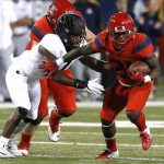 Arizona running back J.J. Taylor (21) stiff arms an Oregon defender in the first half during an NCAA college football game, Saturday, Oct. 27, 2018, in Tucson, Ariz. (AP Photo/Rick Scuteri)