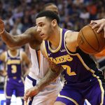 Los Angeles Lakers guard Lonzo Ball (2) drives around Phoenix Suns guard Isaiah Canaan during the first half of an NBA basketball game, Wednesday, Oct. 24, 2018, in Phoenix. (AP Photo/Matt York)