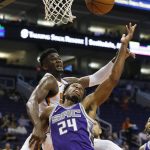 Sacramento Kings guard Buddy Hield (24) has his shot blocked by Phoenix Suns center Deandre Ayton, left, during the first half of a preseason NBA basketball game Monday, Oct. 1, 2018, in Phoenix. (AP Photo/Ross D. Franklin)