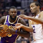 Los Angeles Lakers guard Lance Stephenson drives past Phoenix Suns guard Elie Okobo (2) during the first half of an NBA basketball game, Wednesday, Oct. 24, 2018, in Phoenix. (AP Photo/Matt York)