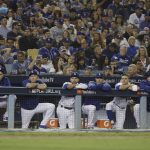 The Los Angeles Dodgers watch the end of the eighth inning in Game 5 of the World Series baseball game against the Boston Red Sox on Sunday, Oct. 28, 2018, in Los Angeles. (AP Photo/David J. Phillip)