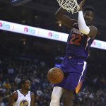 Phoenix Suns' Deandre Ayton (22) scores against the Golden State Warriors during the first half of a preseason NBA basketball game Monday, Oct. 8, 2018, in Oakland, Calif. (AP Photo/Ben Margot)
