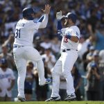 Los Angeles Dodgers' Max Muncy, right, celebrates his two-run home run with Joc Pederson during the fifth inning of a tiebreaker baseball game against the Colorado Rockies, Monday, Oct. 1, 2018, in Los Angeles. (AP Photo/Jae C. Hong)