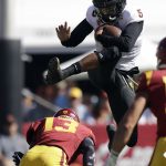 Arizona State quarterback Manny Wilkins, top, leaps over Southern California linebacker Levi Jones (13) during the first half of an NCAA college football game Saturday, Oct. 27, 2018, in Los Angeles. (AP Photo/Marcio Jose Sanchez)