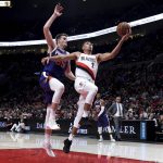 Portland Trail Blazers guard Wade Baldwin IV, right, drives to the basket next to Phoenix Suns forward Dragan Bender during the second half of an NBA preseason basketball game in Portland, Ore., Wednesday, Oct. 10, 2018. (AP Photo/Steve Dykes)