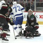 Arizona Coyotes goalie Antti Raanta (32) makes a save on the redirect attempt by Tampa Bay Lightning's Adam Erne (73) during the first period of an NHL hockey game, Saturday, Oct. 27, 2018, in Glendale, Ariz. (AP Photo/Ralph Freso)