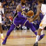 Los Angeles Lakers forward LeBron James (23) drives past Phoenix Suns forward Trevor Ariza during the first half of an NBA basketball game, Wednesday, Oct. 24, 2018, in Phoenix. (AP Photo/Matt York)