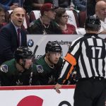 Arizona Coyotes coach Rick Tocchet has a few words for referee Frederick L'Ecuyer (17) during the team's NHL hockey game against the Anaheim Ducks, during the first period Saturday, Oct. 6, 2018, in Glendale, Ariz. (AP Photo/Darryl Webb)