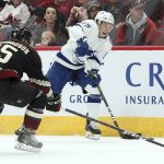 Tampa Bay Lightning's Yanni Gourde (37) advances the puck upice as Arizona Coyotes' Brad Richardson (15) defends during the first period of an NHL hockey game, Saturday, Oct. 27, 2018, in Glendale, Ariz. (AP Photo/Ralph Freso)