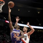 Phoenix Suns guard Davon Reed, left, drives to the basket past Portland Trail Blazers forward Jake Layman during the first half of an NBA preseason basketball game in Portland, Ore., Wednesday, Oct. 10, 2018. (AP Photo/Steve Dykes)