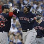 Boston Red Sox's Steve Pearce celebrates with J.D. Martinez (28) and Andrew Benintendi after hitting a two-run home run during the first inning in Game 5 of the World Series baseball game on Sunday, Oct. 28, 2018, in Los Angeles. (AP Photo/David J. Phillip)