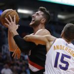 Portland Trail Blazers center Jusuf Nurkic is fouled by Phoenix Suns forward Ryan Anderson (15) during the first half of an NBA preseason basketball game Friday, Oct. 5, 2018, in Phoenix. (AP Photo/Rick Scuteri)