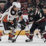 Anaheim Ducks' Rickard Rakell (67) battles for the puck with Arizona Coyotes' Oliver Ekman-Larsson (23) during the first period of an NHL hockey game Saturday, Oct. 6, 2018, in Glendale, Ariz. (AP Photo/Darryl Webb)