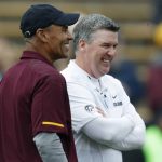 Arizona State head coach Herm Edwards, front, jokes with Colorado head coach Mike MacIntyre before an NCAA college football game Saturday, Oct. 6, 2018, in Boulder, Colo. (AP Photo/David Zalubowski)