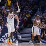 Phoenix Suns center Deandre Ayton (22) and Isaiah Canaan (0) react to a call during the second quarter of an NBA basketball game against the Denver Nuggets, Saturday, Oct. 20, 2018, in Denver. (AP Photo/Jack Dempsey)