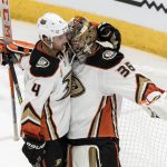 Anaheim Ducks goalie John Gibson (36) gets a hug from Cam Fowler (4) after shutting out the Arizona Coyotes in an NHL hockey game Saturday, Oct. 6, 2018, in Glendale, Ariz. (AP Photo/Darryl Webb)