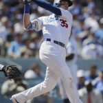 Los Angeles Dodgers' Cody Bellinger follows through after hitting a two-run home run during the fourth inning of a tiebreaker baseball game against the Colorado Rockies, Monday, Oct. 1, 2018, in Los Angeles. (AP Photo/Jae C. Hong)