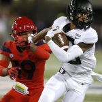 Oregon wide receiver Dillon Mitchell stiff arms Arizona safety Scottie Young Jr. (19) in the first half during an NCAA college football game, Saturday, Oct. 27, 2018, in Tucson, Ariz. (AP Photo/Rick Scuteri)