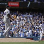Colorado Rockies starting pitcher German Marquez, left, looks away as Los Angeles Dodgers' Cody Bellinger rounds the bases after hitting a two-run home run during the fourth inning of a tiebreaker baseball game, Monday, Oct. 1, 2018, in Los Angeles. (AP Photo/Jae C. Hong)