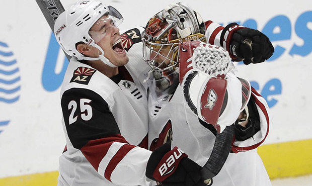 Arizona Coyotes' Nick Cousins (25) celebrates with goaltender Antti Raanta after the Coyotes defeat...