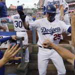 Los Angeles Dodgers' David Freese celebrates in the dugout after his home run against the Boston Red Sox during the first inning in Game 5 of the World Series baseball game on Sunday, Oct. 28, 2018, in Los Angeles. (AP Photo/David J. Phillip)