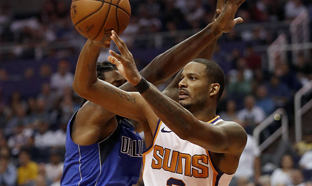 Phoenix Suns forward Trevor Ariza (3) passes around Dallas Mavericks center DeAndre Jordan during t...