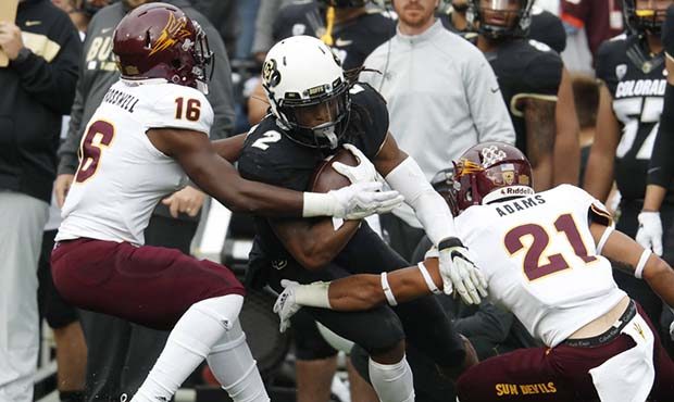 Colorado wide receiver Laviska Shenault Jr., center, is tackled after catching a pass by Arizona St...
