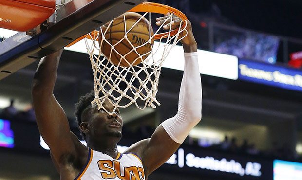 Phoenix Suns center Deandre Ayton (22) dunks over Sacramento Kings forward Harry Giles (20) during ...