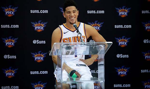 Devin Booker is determined to help Deandre Ayton have a more memorable start with the Suns. (Photo ...