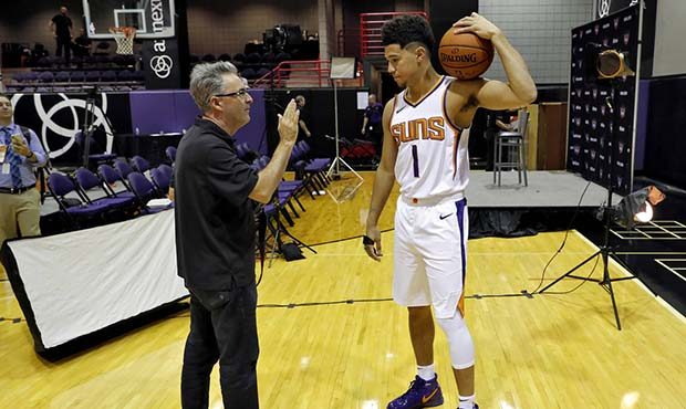 Photographer Rob Schumacher poses Phoenix Suns' Devin Booker during media day at the NBA basketball...