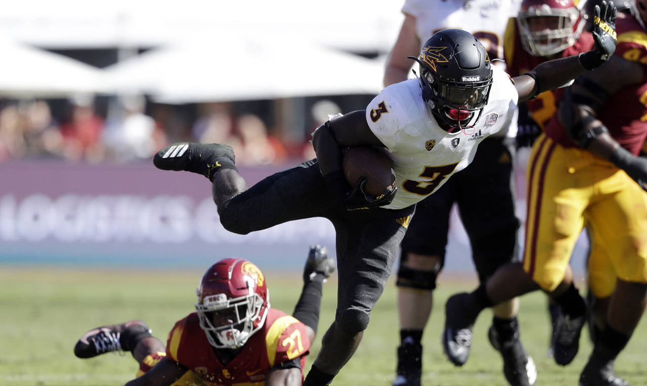 Arizona State's Eno Benjamin gets tackled by Stanford's Michael Williams during the first half of a...