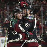 Arizona Coyotes' Vinnie Hinostroza (13) celebrates with teammate Jordan Oesterle (82) after scoring a second-period goal against the Tampa Bay Lightning during an NHL hockey game, Saturday, Oct. 27, 2018, in Glendale, Ariz. (AP Photo/Ralph Freso)