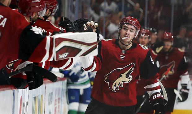 Arizona Coyotes center Clayton Keller (9) celebrates with teammates after scoring a goal in the thi...