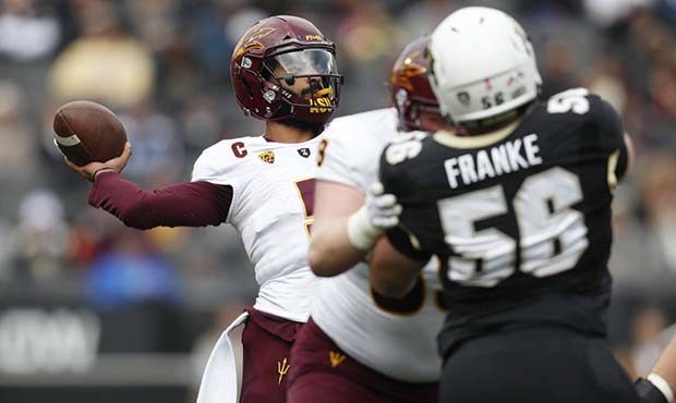 Arizona State quarterback Manny Wilkins, back, throws a pass against against Colorado in the first ...