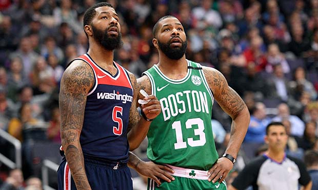 Washington Wizards forward Markieff Morris (5) stands next to his brother and Boston Celtics forwar...